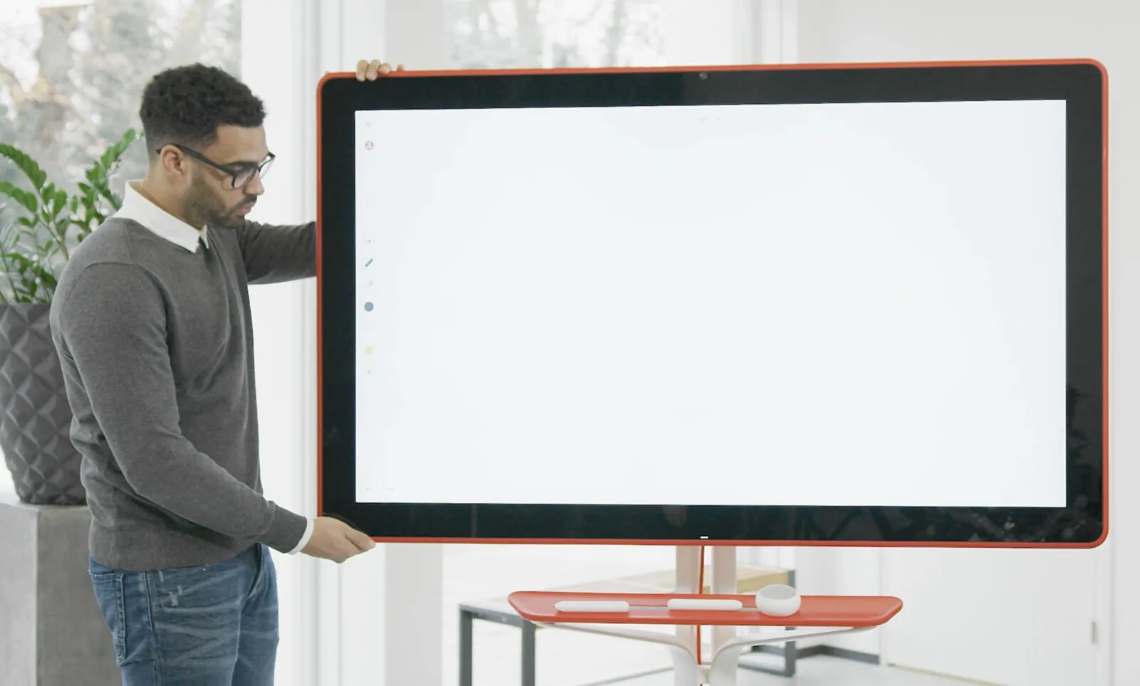 Een man zet een Google Jamboard klaar, het scherm nog leeg