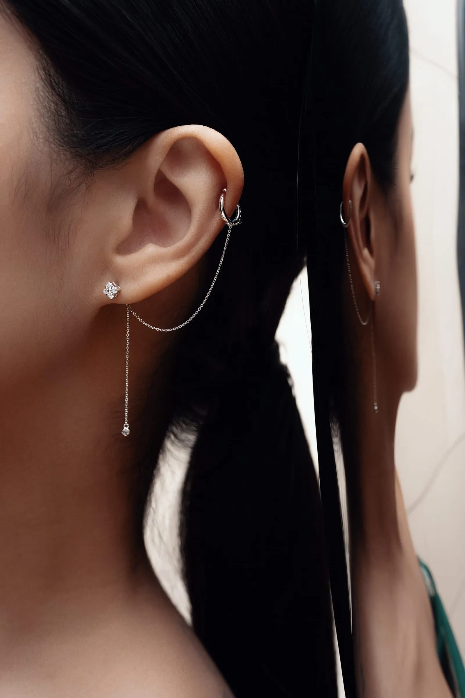 Diamanten oorketting van de lel naar een helixring, verdubbeld in een spiegel